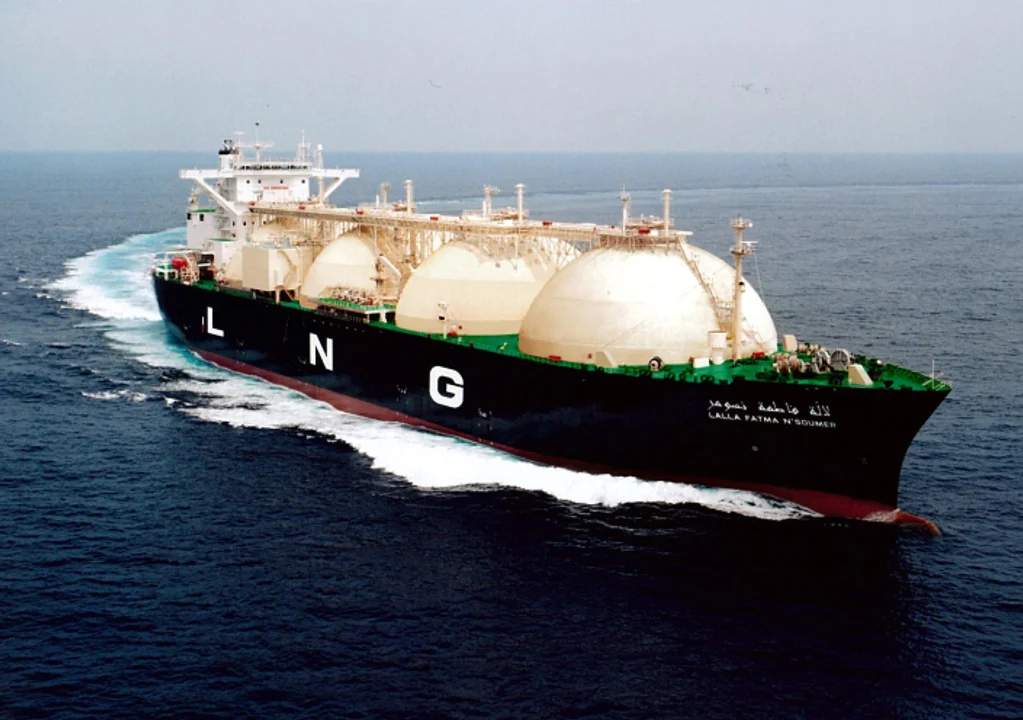 Se observa un buque metanero diseñado para el transporte de gas natural licuado (GNL). navegando sobre aguas tranquilas. Las letras "LNG" (siglas en inglés de gas natural licuado) son claramente visibles en su casco.