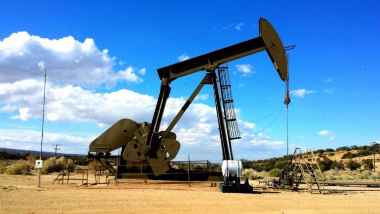Bomba extractora de petróleo tipo balanc?n operando en un yacimiento terrestre bajo cielo despejado.