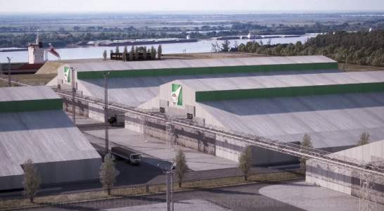 Vista aérea de las instalaciones industriales de la empresa ACA sobre la ribera del rño Paran?, con varios galpones de techo verde y gris.